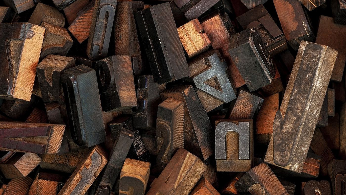 Heap of worn wooden letterpress type blocks